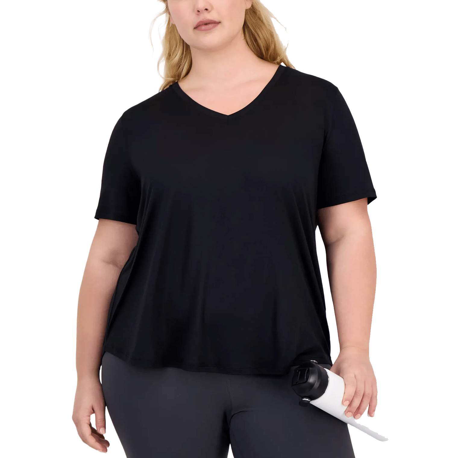 A person is wearing a black V-neck short-sleeved shirt and dark leggings while holding a white water bottle.