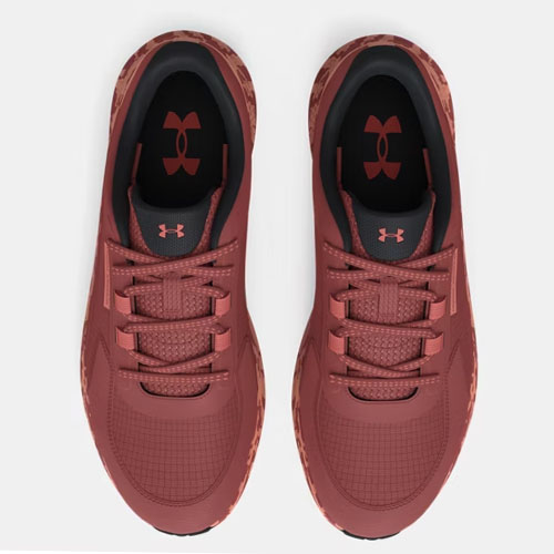 A pair of maroon Under Armour sneakers with black insoles and logo.