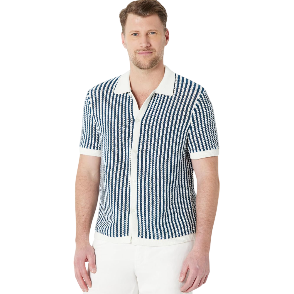 A man is wearing a short-sleeved knitted shirt with a navy and white stripe pattern and a white collar, along with white pants.