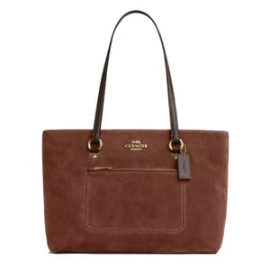 A brown suede Coach tote bag with dual leather handles, featuring a front zip pocket and the Coach logo in gold-tone hardware.