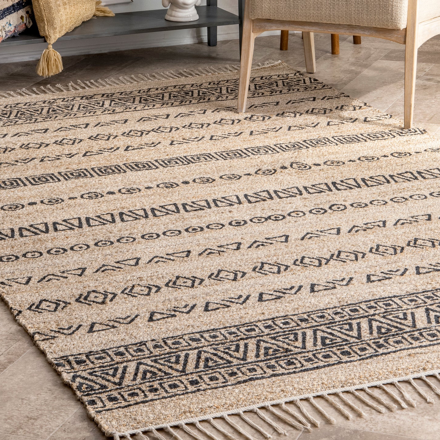 Beige and black 5' x 8' area rug with geometric patterns and fringe edges, featuring triangular and rectangular designs in horizontal rows.