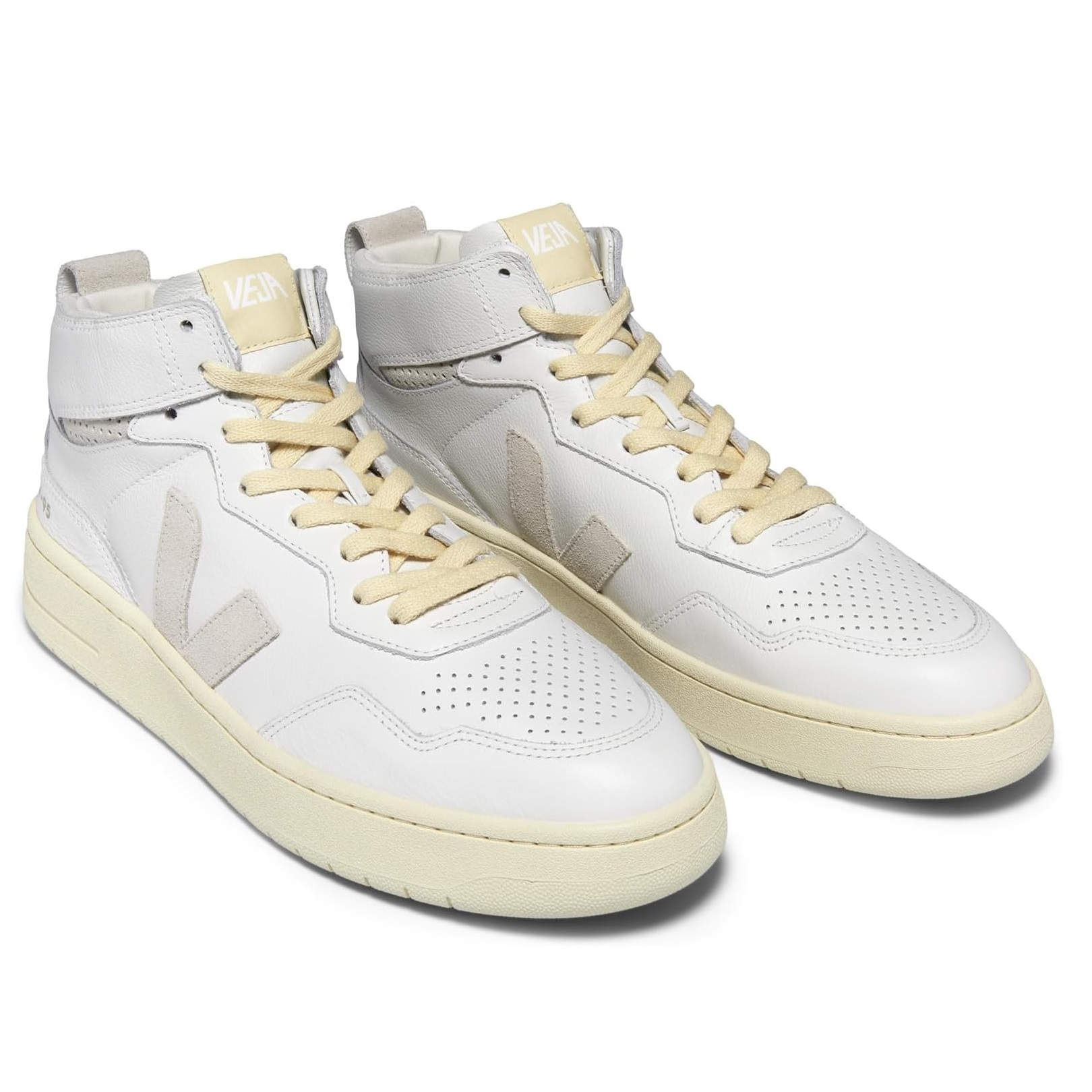White Veja high-top sneakers with perforated detailing, beige laces, and a classic V logo on the side.