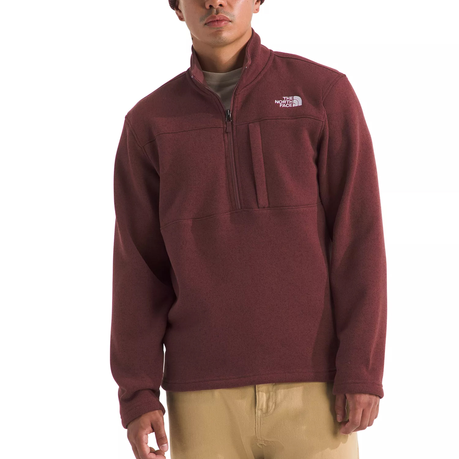 A maroon The North Face pullover fleece with a quarter-zip closure and a chest pocket. The fleece is paired with beige pants.