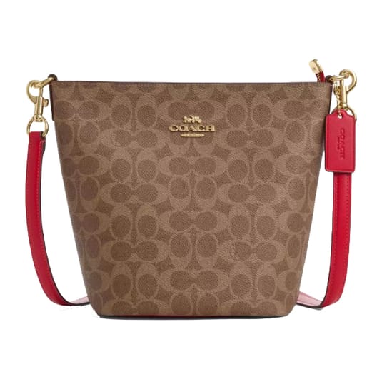 A Coach handbag with a signature brown monogram pattern and a red leather strap. The bag features gold-tone hardware and a Coach logo tag.