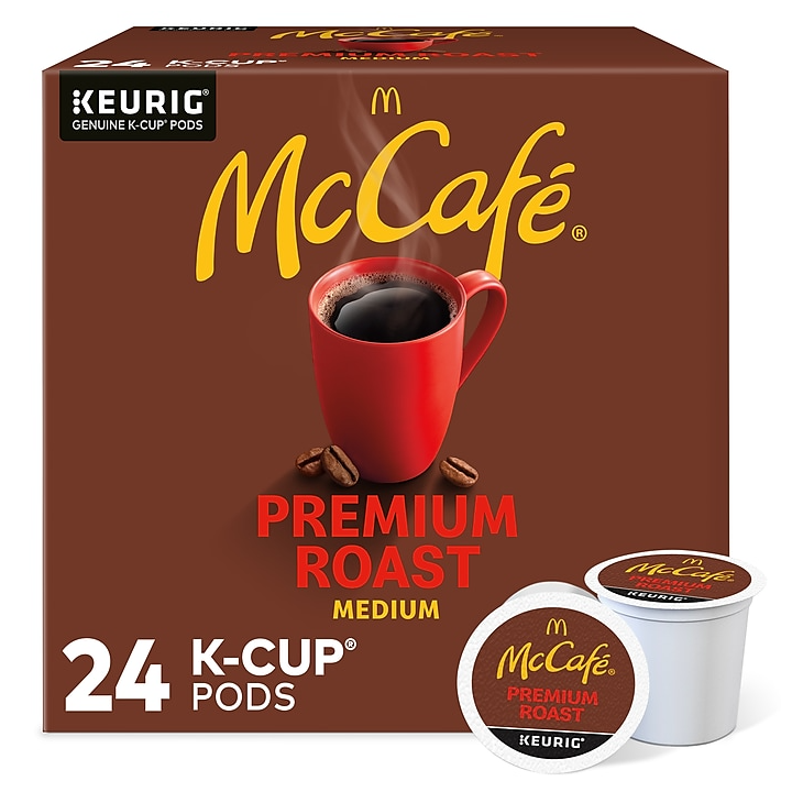 A box of McCafe Premium Roast Medium Keurig K-Cup coffee pods, with a total count of 24 pods, is displayed with a red mug and coffee beans.