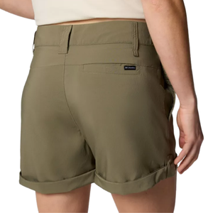 A person wearing olive green Columbia shorts with rolled cuffs and belt loops, featuring a small label on the back pocket.