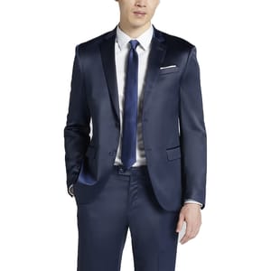 A man in a navy blue satin suit with a matching tie over a white shirt, featuring a pocket square and two-button suit jacket.