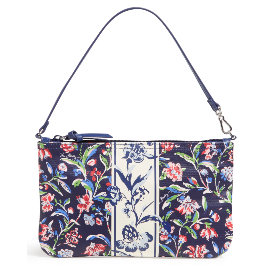 A floral-patterned handbag with a navy and cream color scheme, featuring a zip closure and a detachable shoulder strap.