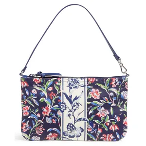 A floral-patterned handbag with a navy and cream color scheme, featuring a zip closure and a detachable shoulder strap.