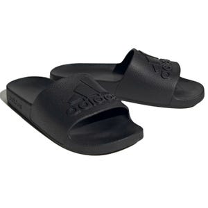 A pair of black Adidas slides featuring the Adidas logo on the strap, designed for casual comfort.