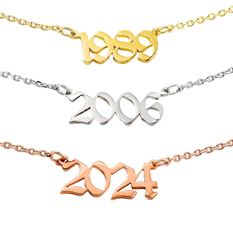 Three necklaces displaying years in different metal finishes: \“1989\“ in gold tone, \“2006\“ in silver tone, and \“2024\“ in rose gold tone, each mounted on delicate chains.