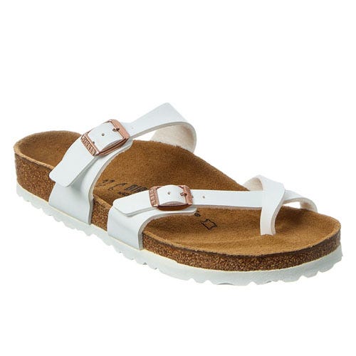 White sandal with two straps and buckles, featuring a cork footbed and white sole.