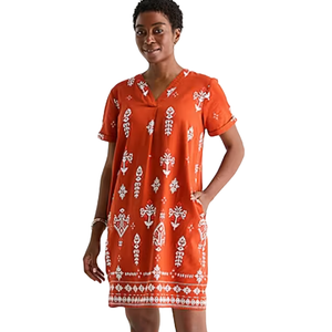Short-sleeve, knee-length orange dress with white geometric and floral patterns.