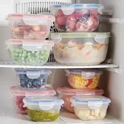 Assorted frozen foods stored in clear, airtight containers with colored lids, neatly arranged in a freezer.