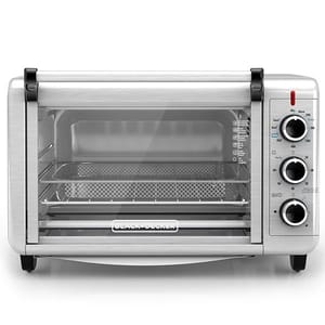 A Black+Decker countertop convection toaster oven with dials for temperature, function, and timer settings.