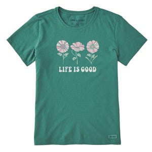 A green t-shirt with a \“Life is Good\“ slogan and daisy flower graphic.