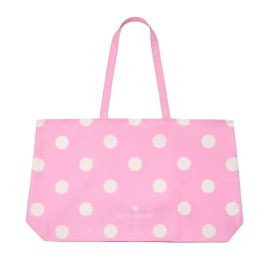 A pink Kate Spade tote bag with white polka dots, featuring long handles and a spacious design.