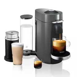 A Nespresso Vertuo coffee machine with an attached Aeroccino milk frother, a clear water tank, and two glasses filled with coffee drinks.