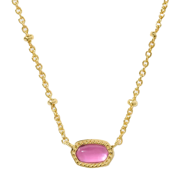 A gold chain necklace features a small, oval-shaped pink stone set in a gold bezel, accented with delicate beaded details.