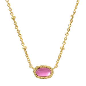 A gold chain necklace features a small, oval-shaped pink stone set in a gold bezel, accented with delicate beaded details.