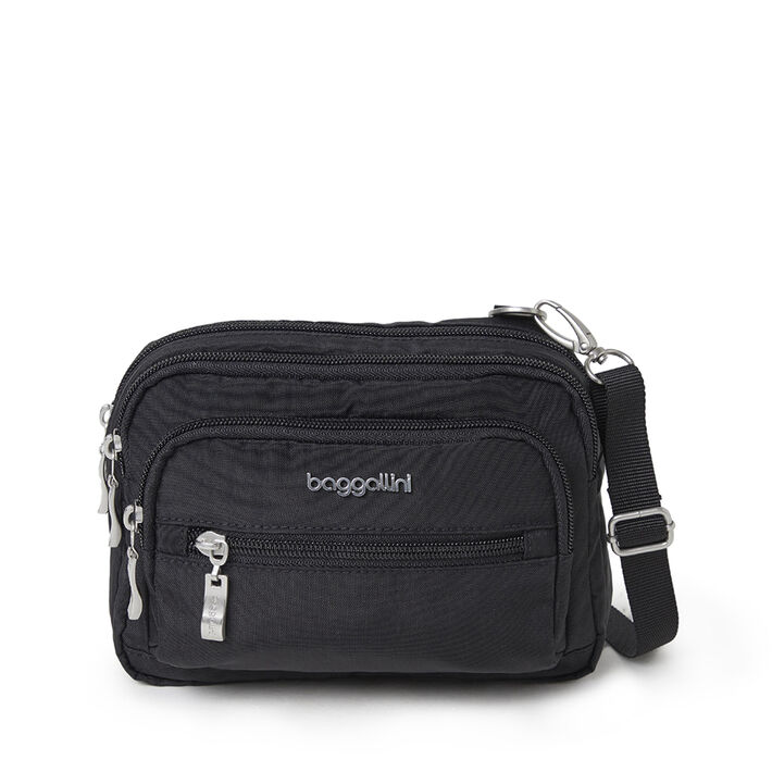 A black Baggallini crossbody bag with multiple zippered compartments and an adjustable strap.