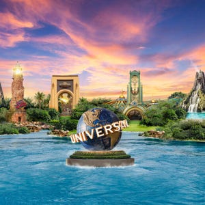 A globe statue with the \“Universal\“ logo is set against a backdrop of a vibrant sunset, featuring various themed attractions and iconic structures from Universal theme parks.