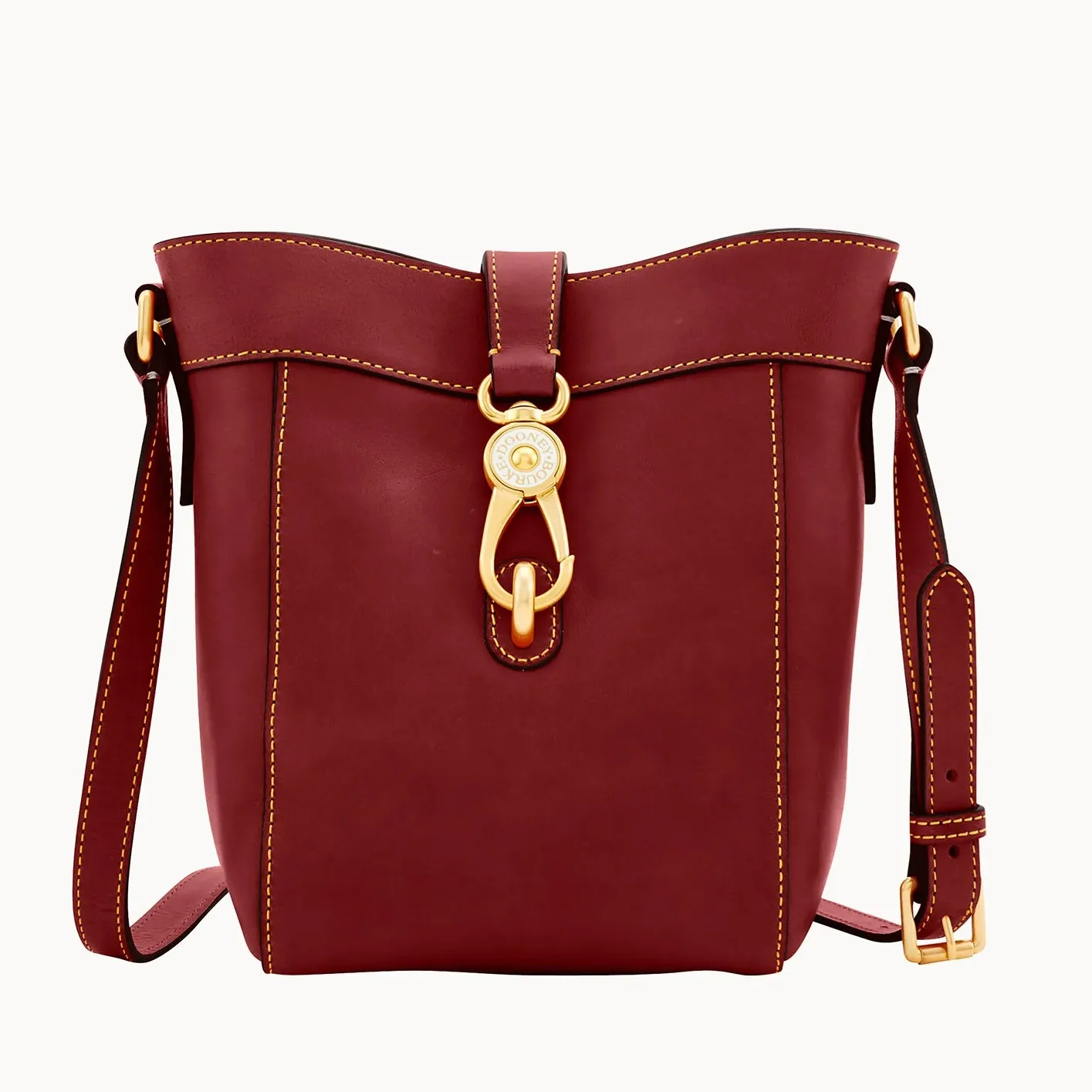 A red leather bucket bag with a gold-tone clasp and an adjustable shoulder strap.