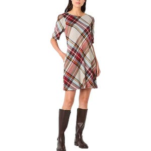 A knee-length plaid dress with half sleeves in a mix of burgundy, beige, and blue tones, paired with dark knee-high boots.