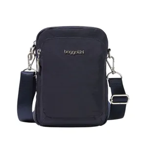 A compact, navy blue crossbody bag with a detachable strap, featuring a front zippered pocket and silver hardware.