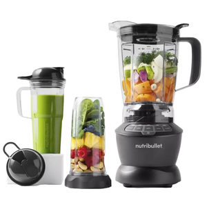 The NutriBullet Blender & Cup Set includes a blender base with a large pitcher filled with various fruits and vegetables, a tall cup with a green smoothie, and a smaller cup containing nuts, berries, and greens, all featuring secure lids.