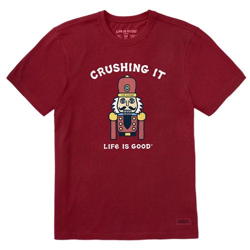 A red T-shirt features a graphic of a nutcracker with the text \“CRUSHING IT\“ above and \“LIFE IS GOOD\“ below.