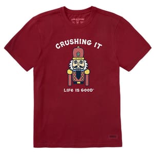 A red T-shirt features a graphic of a nutcracker with the text \“CRUSHING IT\“ above and \“LIFE IS GOOD\“ below.