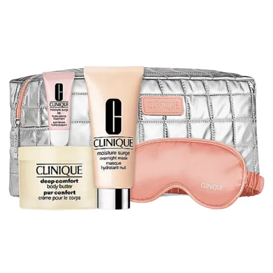 Clinique skincare set featuring Moisture Surge Overnight Mask, Deep Comfort Body Butter, and a pink sleep mask, accompanied by a quilted silver cosmetic pouch.