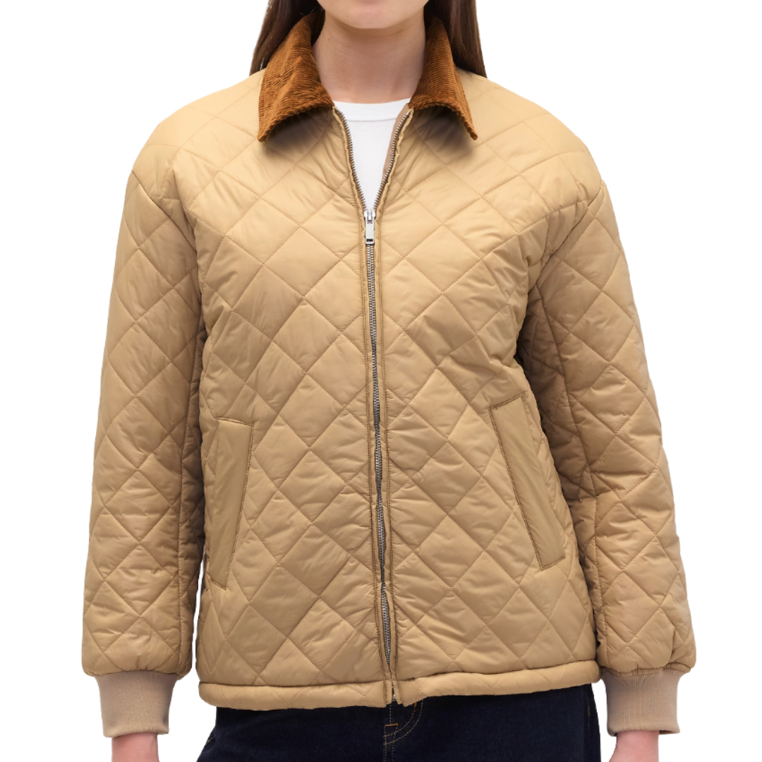 Tan quilted jacket with a front zipper, corduroy collar, and ribbed cuffs, worn over a white top and dark pants.
