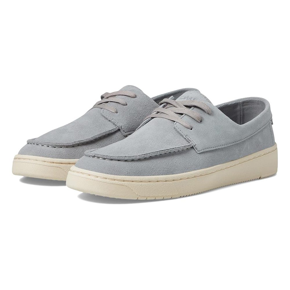 A pair of light grey suede boat shoes with white laces and soles.