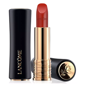 A red lipstick with a golden base and a black cap, branded Lancôme.