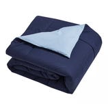 A reversible navy and light blue comforter, neatly folded.