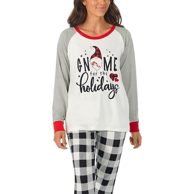 Women's pajama set features a long-sleeve top with light gray sleeves and red cuffs, displaying \“Gnome for the holidays\“ with a gnome graphic. The pants have a black and white buffalo plaid pattern.
