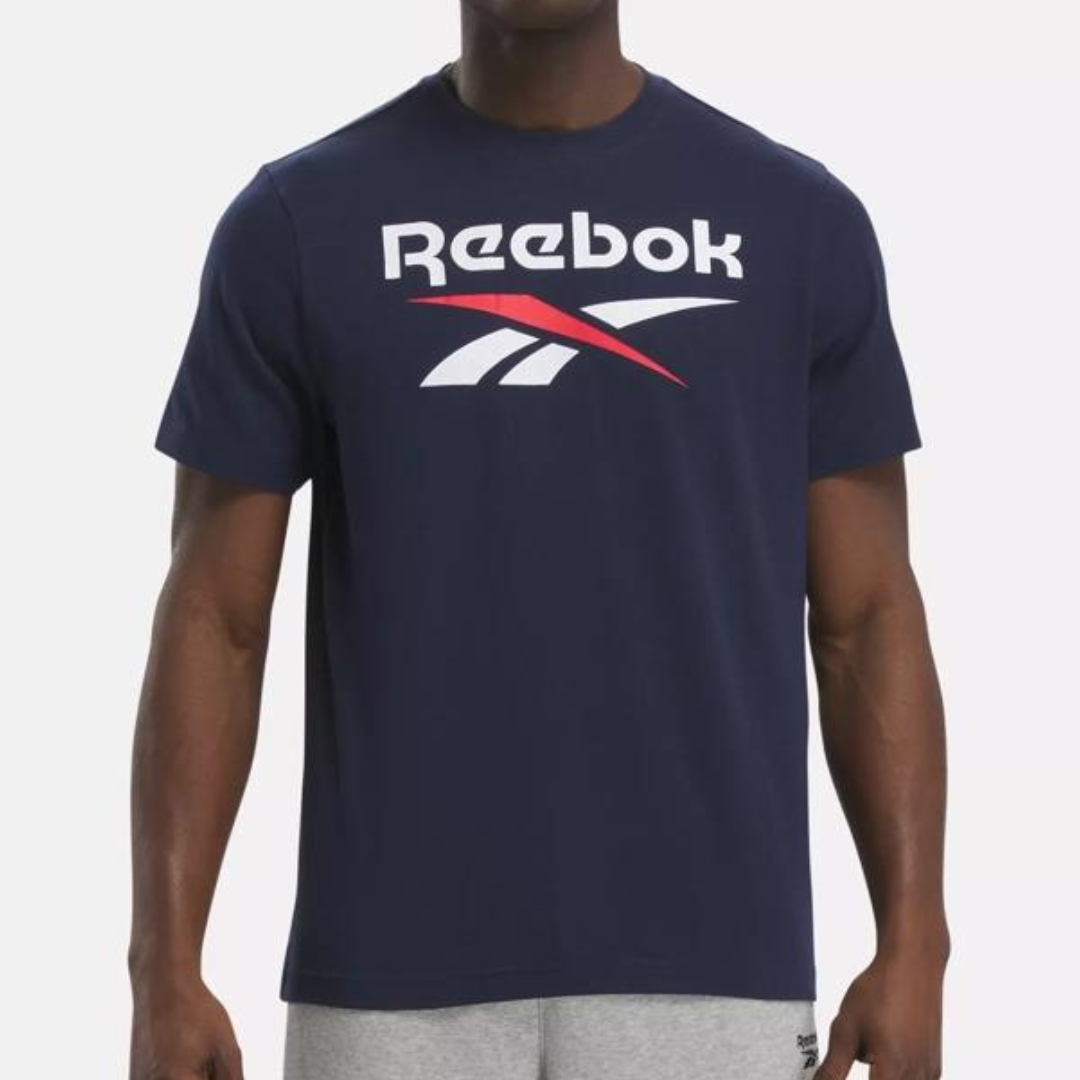 A person is wearing a dark blue Reebok t-shirt with the brand's logo on the front.