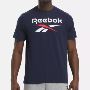 A person is wearing a dark blue Reebok t-shirt with the brand's logo on the front.