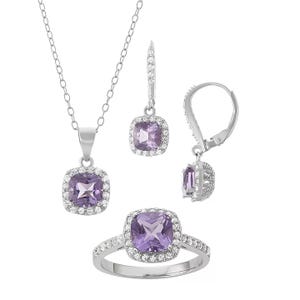 Sterling silver jewelry set includes a necklace with a square-cut amethyst pendant, a matching pair of earrings, and a ring. Each piece features a central purple amethyst stone surrounded by a halo of small sparkling stones.