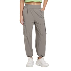 Gray cargo pants with an elastic high waistband and cuffed ankles, featuring side pockets and a relaxed fit. Paired with chunky white sneakers.