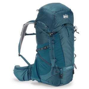 A blue REI Co-op Traverse 60 backpack designed for hiking, featuring multiple compartments, adjustable straps, a padded hip belt, and durable fabric.