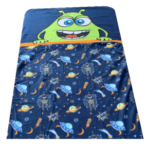 A children's blanket featuring a cheerful green alien on a blue background, with patterns of planets, stars, rockets, and UFOs.