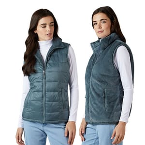 Two images display a reversible vest worn by a woman, featuring a quilted design on one side and a plush fleece on the other, both in a blue-gray color.