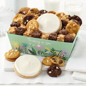A box of assorted cookies and brownies, including chocolate chip, white chocolate chip, and frosted cookies, with a \“Thinking of You\“ message and floral design.