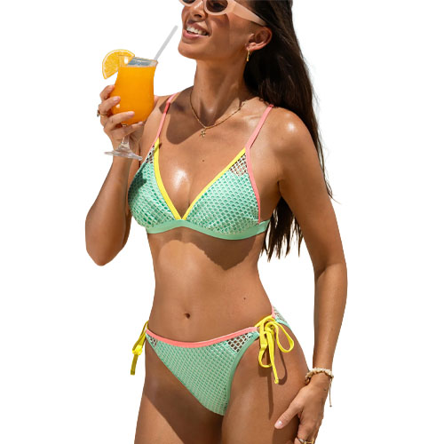 A woman wearing a colorful mesh bikini, holding a glass of orange juice with a straw. The bikini features light blue and yellow with pink trim, and the top and bottoms have a tied design.