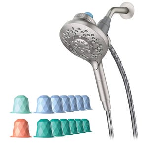 The Moen Aromatherapy Showerhead is a brushed metal showerhead with multiple spray settings and an attached flexible hose. It includes colored scent capsules for aromatherapy, designed to be inserted into the showerhead for a scented shower experience.
