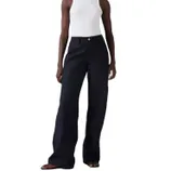 A person is wearing high-waisted, wide-leg black pants paired with a white sleeveless top and sandals.