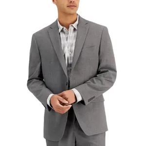 A person wearing a light gray suit jacket over a plaid shirt. The suit has a notched lapel and three-button cuffs.